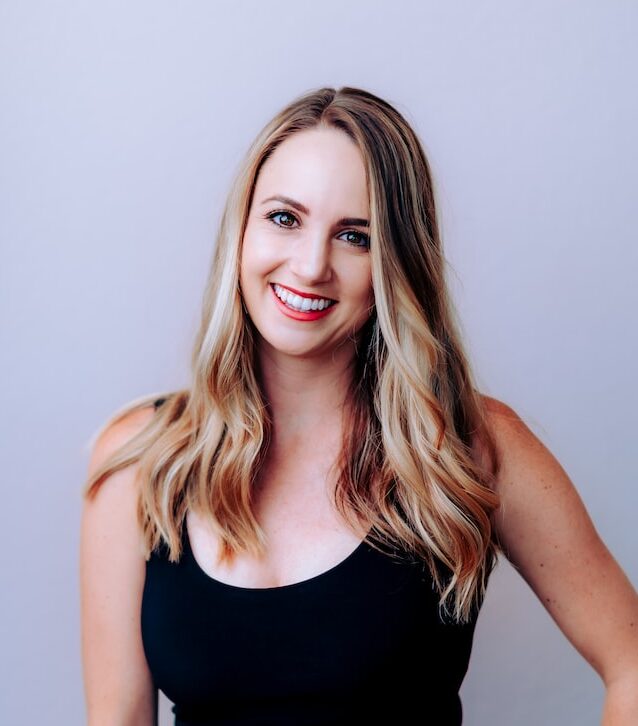 woman in black tank top smiling