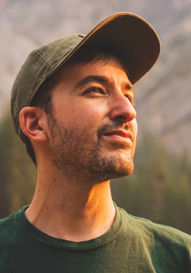Photo by Jeffrey Keenan man in green crew neck shirt and black hat