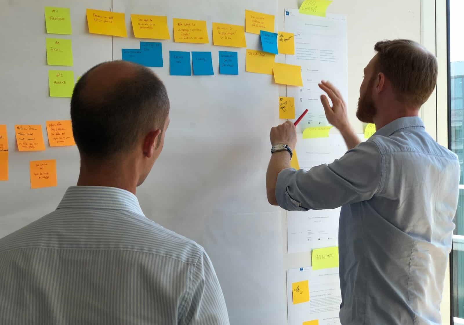 man in gray shirt facing sticky notes